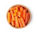 Top view of a group of organic small baby carrots in wood bowl isolated Royalty Free Stock Photo