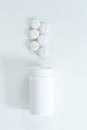 Top view of a group of pills and plastic bottle on white Royalty Free Stock Photo