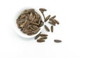 Top view group of roasted sunflower seeds in a white small bowl on white background, some sunflower seeds is spread outside Royalty Free Stock Photo