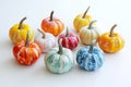 top view group of small pumpkins painted in vibrant bright colors on white background Royalty Free Stock Photo