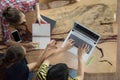 Top view group of teenage friends to be busy working in team with reports and laptop at University Royalty Free Stock Photo