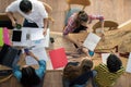 Top view group of teenage friends to be busy working in team with reports and laptop at University Royalty Free Stock Photo