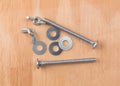 Wing nuts bolts and washers on plywood Royalty Free Stock Photo