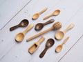 Top view of group of wooden spoons, scoop and honey drop wooden stick isolated on table.