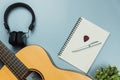 Top view guitar and note book and headphone