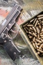 Top view of gun and ammunition box on the table Royalty Free Stock Photo