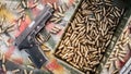 Top view of gun and ammunition box on the table Royalty Free Stock Photo