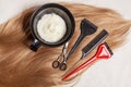 Top view of hair, scissors, comb and hair dye, beauty hair salon concept Royalty Free Stock Photo