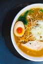 Top view of half Ramen Pork Bone Soup Tonkotsu Ramen with Chashu Pork, Scallion, Sprout, Carrot, Menma, Dried Seaweed and boiled