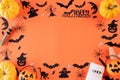 Top view of Halloween crafts, orange pumpkin, ghost, bat and spider on orange background with copy space for text. halloween Royalty Free Stock Photo