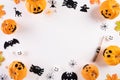 Top view of Halloween crafts, orange pumpkin, ghost, bat and spider on white background with copy space for text. halloween Royalty Free Stock Photo