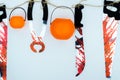 Top view of Halloween decoration, jack o lantern, and bloodstain on the knife and saw on white background with copy space for text