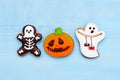 Top view Halloween gingerbread ghost, skeleton and pumpkin on bl