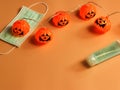 Halloween pumpkin lights ,medical mask and alcohol sanitizer gel on orange background. Halloween , COVID-19 prevention and new Royalty Free Stock Photo