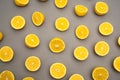 top view of halves of fresh and ripe lemons on grey.