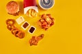 Top view hamburger, french fries and fried chicken on yellow background. Copy space for your text.