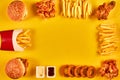 Top view hamburger, french fries and fried chicken on yellow background. Copy space for your text.