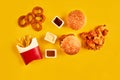 Top view hamburger, french fries and fried chicken on yellow background. Copy space for your text.