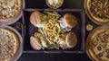 Top view of hamburgers with fries and pizzas