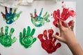 Hand of a child making red and green colourful palm prints Royalty Free Stock Photo