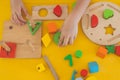 Top view hand of cute little girl playing kids toys in childhood room.