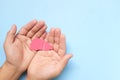 Top view of hand holding liver cutout. Liver health care and protection, hepatitis awareness and organ transplant concept. Royalty Free Stock Photo