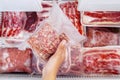 Top view of hand picking a pack of cube red beef Royalty Free Stock Photo
