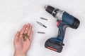 Top view of hand with screwdrivers and battery accu drill on the white background