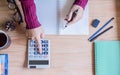 Top view. Hand woman using finances and calculator on table at home office. Royalty Free Stock Photo