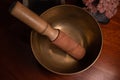 Top view of a handcrafted Tibetan bowl with a stick on a table Royalty Free Stock Photo