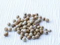 top view of handful of dried white pepper peppercorns, ripe piper nigrum fruits