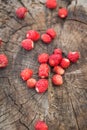 Top view of a handful of strawberries on a wooden background