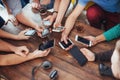 Top view hands circle using phone in cafe - Multiracial friends mobile addicted interior scene from above - Wifi connected people Royalty Free Stock Photo