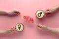 Top view Hands of couple in love holding lollipops and cups of coffee with symbols of venus and mars on milk foam Royalty Free Stock Photo