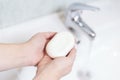 Top view of hands keeping soap cube. Cleaning hands in bathroom. Health care.