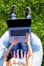 Top view. Woman working on laptop pc computer with blank black empty screen to copy space in park on green grass Royalty Free Stock Photo