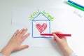 Hands of little girl painting heart