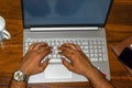 Top view of hands of a man typing on laptop Royalty Free Stock Photo