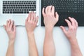 Top view of hands man and woman typing on two black and white laptops on white table Royalty Free Stock Photo