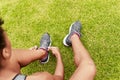 Top view, hands and tie shoes outdoor for fitness, sports or start workout on grass in nature. Above, sneakers and Royalty Free Stock Photo