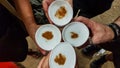 Top view of hands toasting with typical Peruvian drink: Pisco Sour