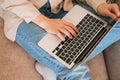 Top view hands typing on a keyboard . Woman sitting on a sofa using laptop Royalty Free Stock Photo