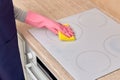 Top view of hands washing an electric stove in rubber gloves and microfiber. Royalty Free Stock Photo