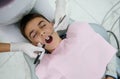 Top view of handsome boy at a dental check-up in white dental clinic with modern equipment. Pediatric dentist examining child`s Royalty Free Stock Photo