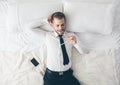 Top view. Handsome businessman with glasses lying on bed Royalty Free Stock Photo