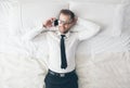 Top view. Handsome businessman with glasses lying on bed Royalty Free Stock Photo