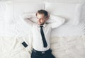 Top view. Handsome businessman relaxing on bed after a tough day at work Royalty Free Stock Photo