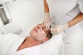 Close-up of handsome mature Caucasian man lying on massage table, and enjoying male beauty treatments at luxury wellness spa Royalty Free Stock Photo
