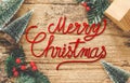 Top view of handwriting red Merry Christmas on rustic wooden tab