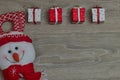 Top view of hanging small Christmas gift boxes on a wooden table with copy space Royalty Free Stock Photo
